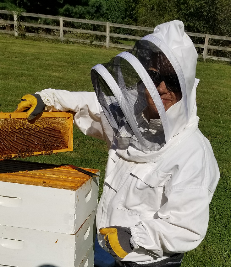 Amy Inspecting a Hive
